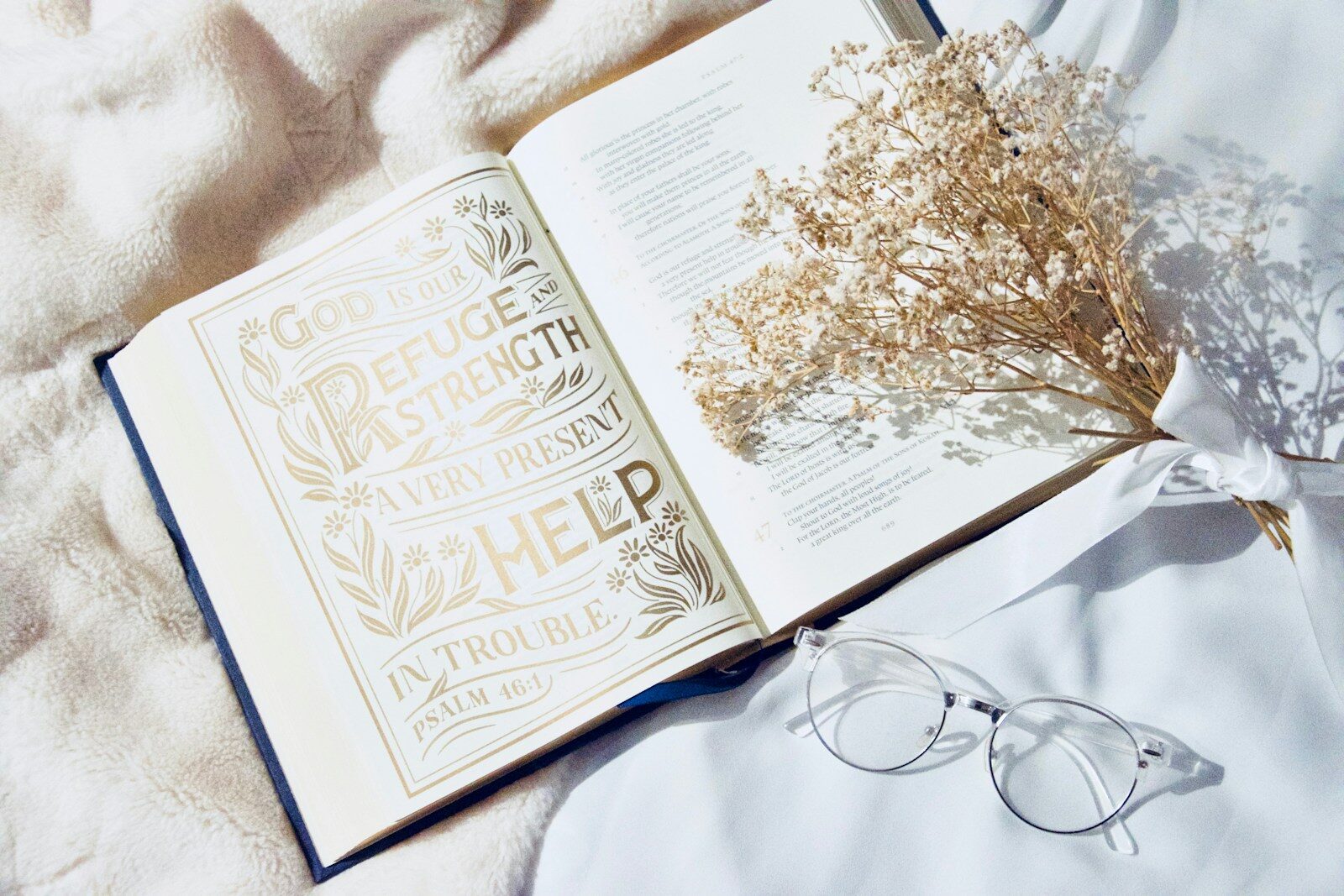 white book page with black frame eyeglasses